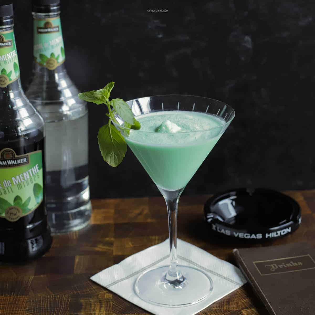 The minty smooth Grasshopper cocktail is a vintage drink with Creme de Menthe and Creme de Coca that is blended for a minty treat.