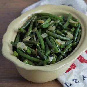 Large bowl of green beans with a serving spoon