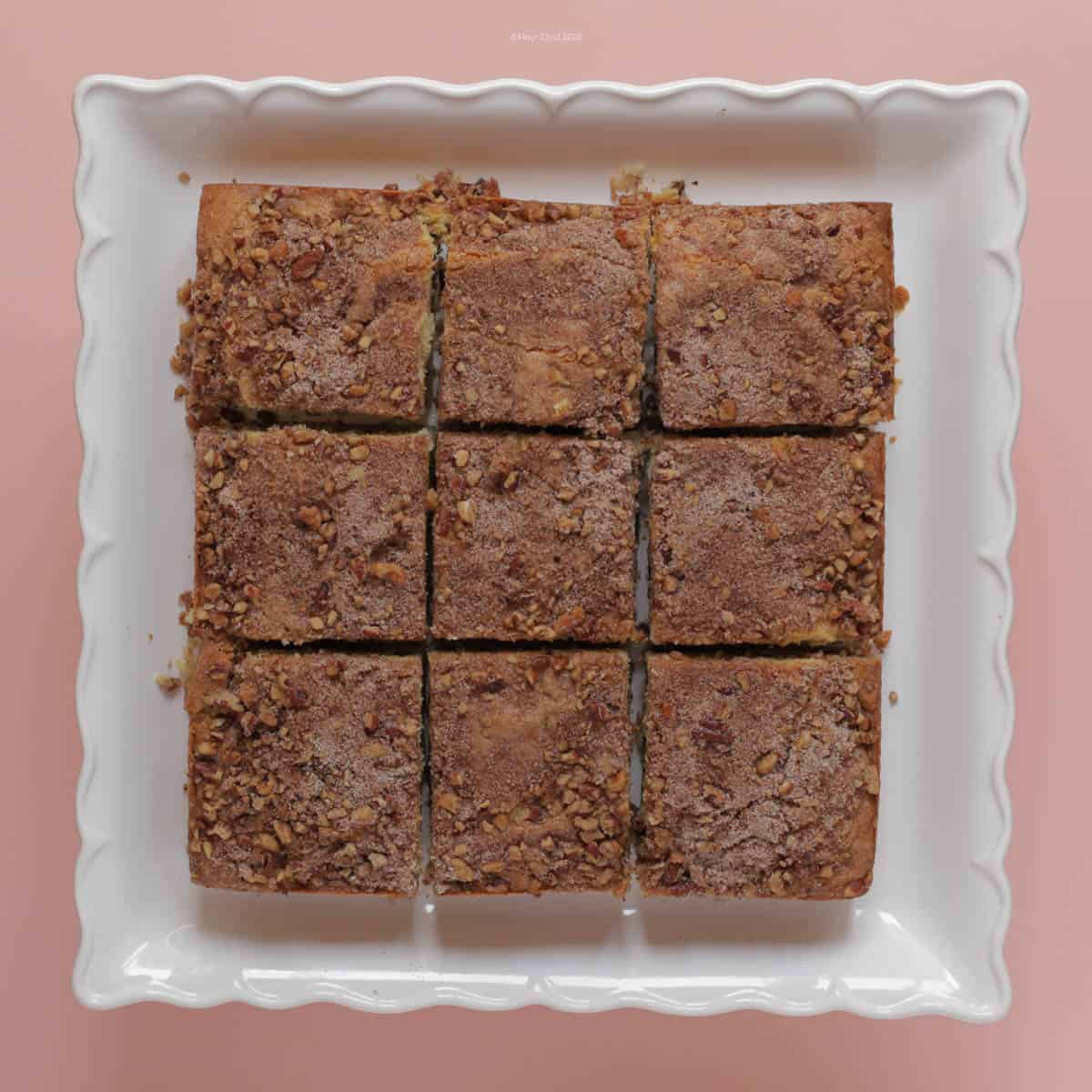 Coffee Cake cut into 9 squares sitting on a pedestal platter