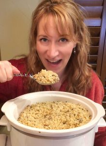 Woman enjoying a large spoon of farfel.