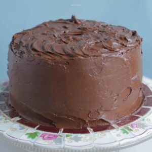 Close up photo of chocolate cake covered in chocolate buttercream frosting