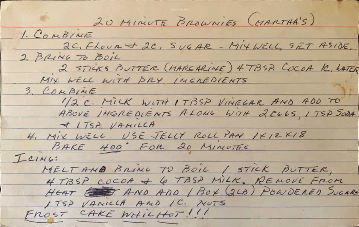 A large index card with the hand written recipe for 20 minutes brownies on it