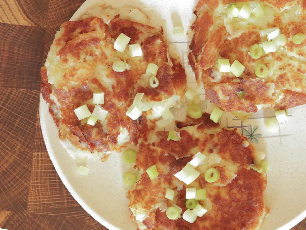 Hearty leftover mashed potato pancakes on a mid century plate