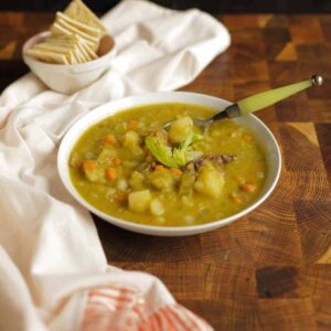 Bowl of Split pea and ham soup with crackers on the side