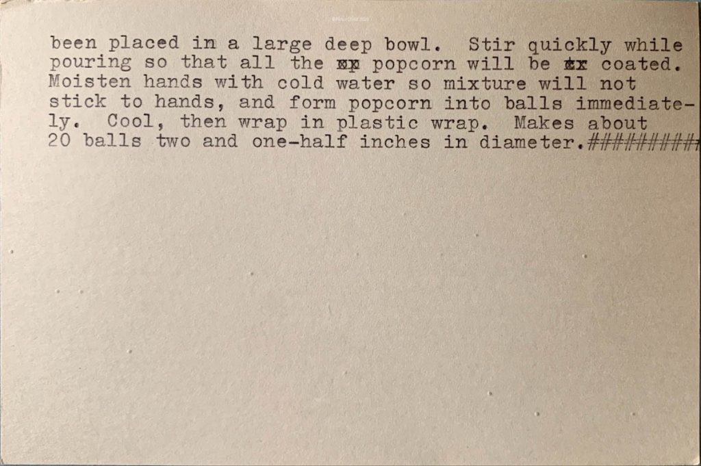 An index card with the typed old fashioned recipe for popcorn balls