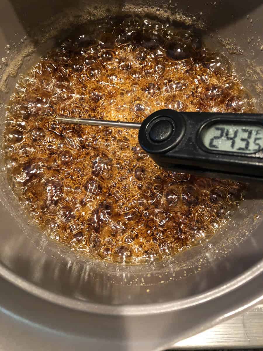 Candy thermometer inserted into boiling syrup