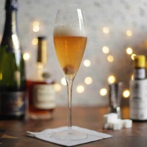 Champagne Cocktail with a white sparkly background