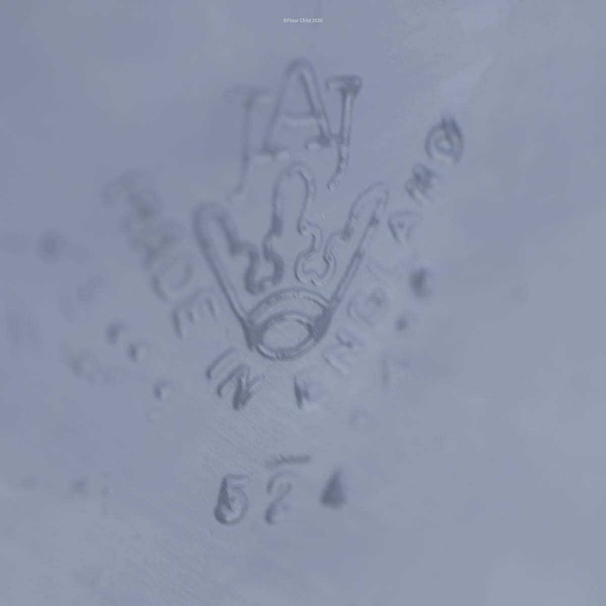 Image of the crown imprint on the bottom of a JAJ pyrex dish