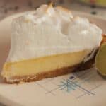 Perfect slice of key lime pie topped high with brown-tipped meringue