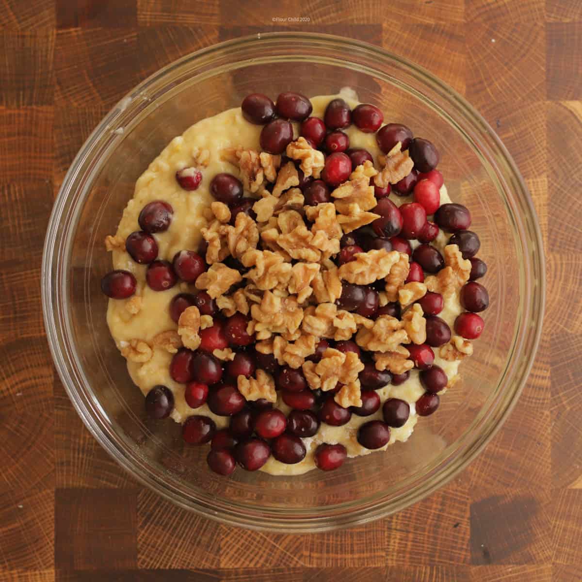 Mixing cranberries and optional nuts into the batter