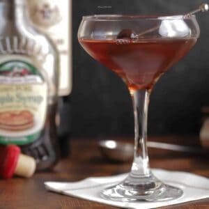 Closeup of a maple manhattan in a coupe glass