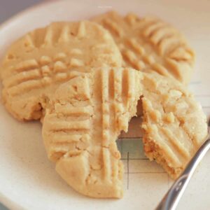 Close up image of 3 peanut butter cookies on a dessert plate