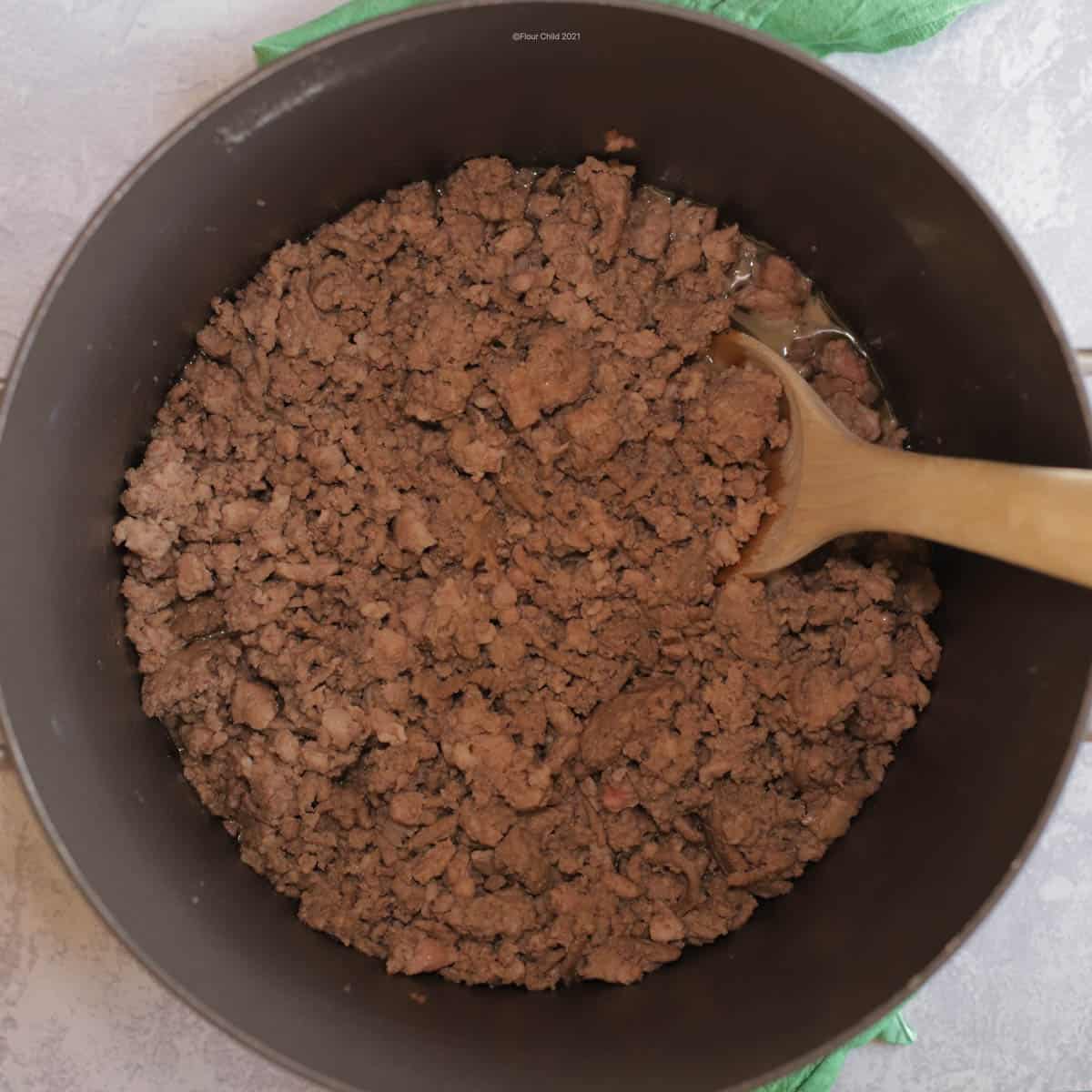 Browning beef and pork with seasonings in a large pot