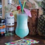 Blue Hawaiian cocktail with spirits and tiki mugs.
