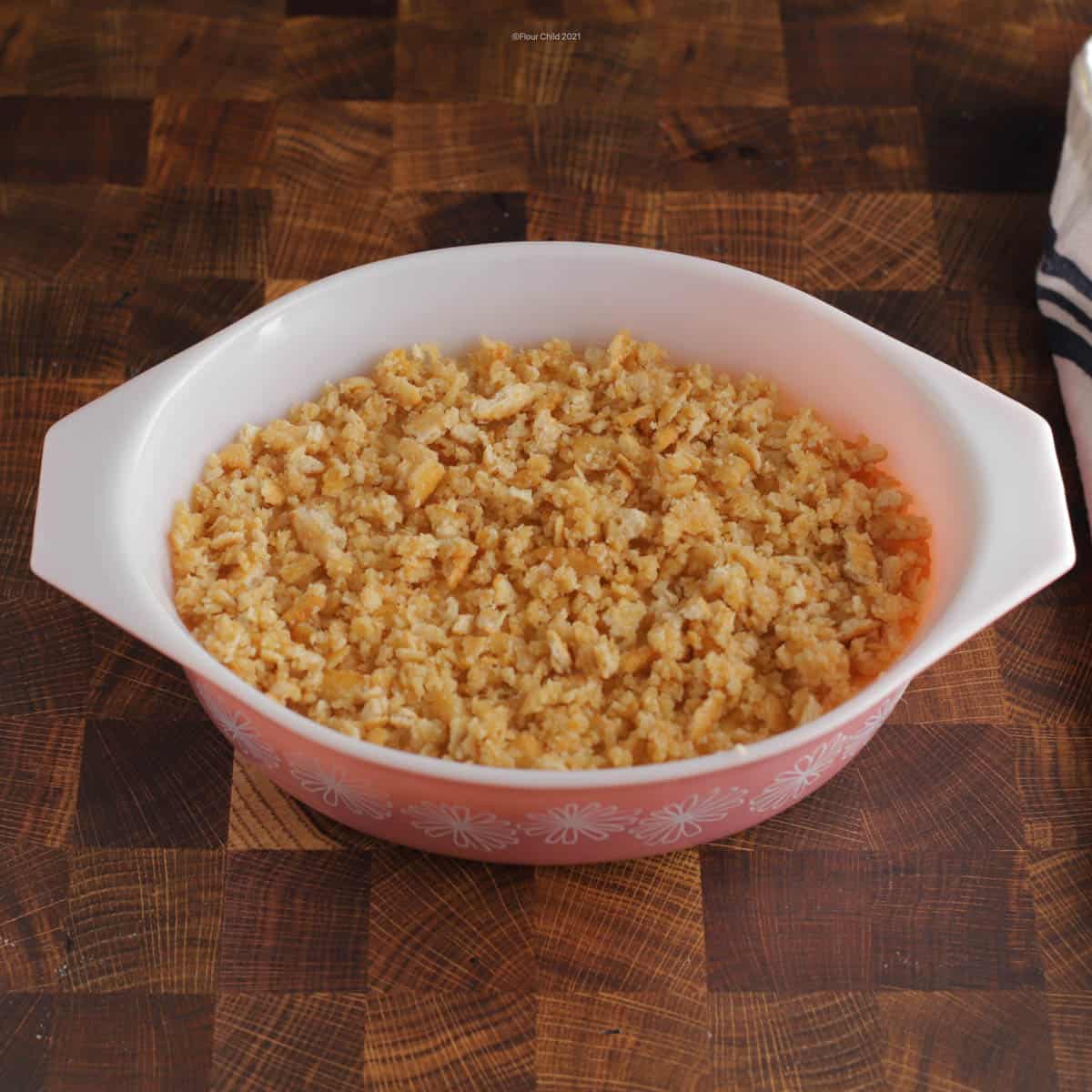 Butter crumbs on top of macaroni and cheese in casserole dish