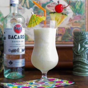 a pina colada tiki cocktail in a hurricane glass.