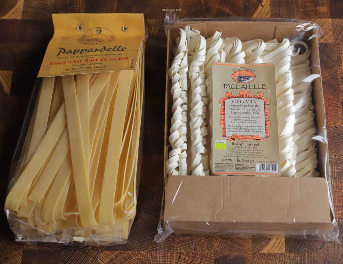 Packages of pappardelle and tagliatelle pasta, side by side