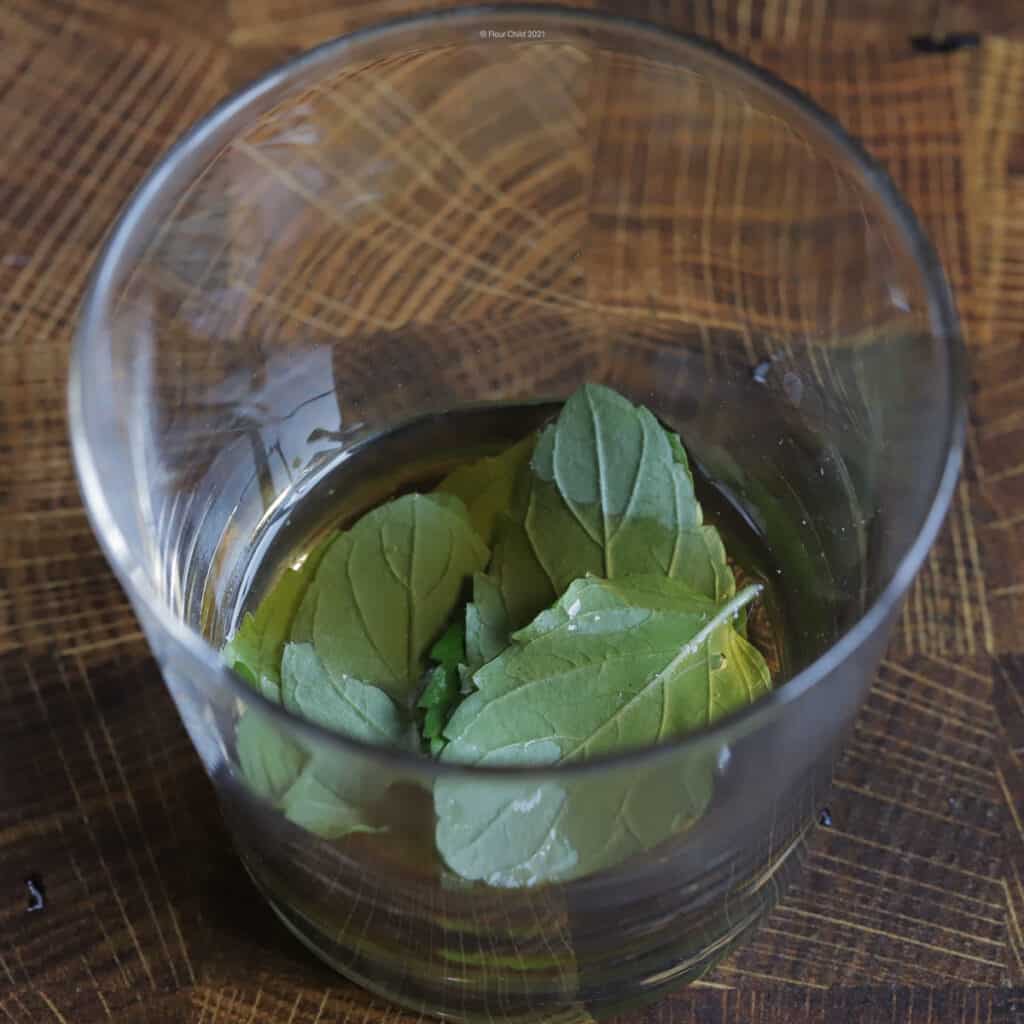 mint leaves muddled in simple syrup.
