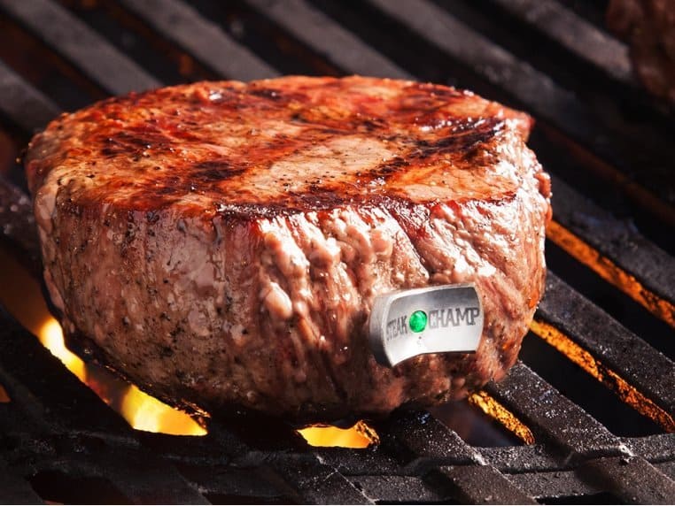 Steak with steak champ thermometer in it