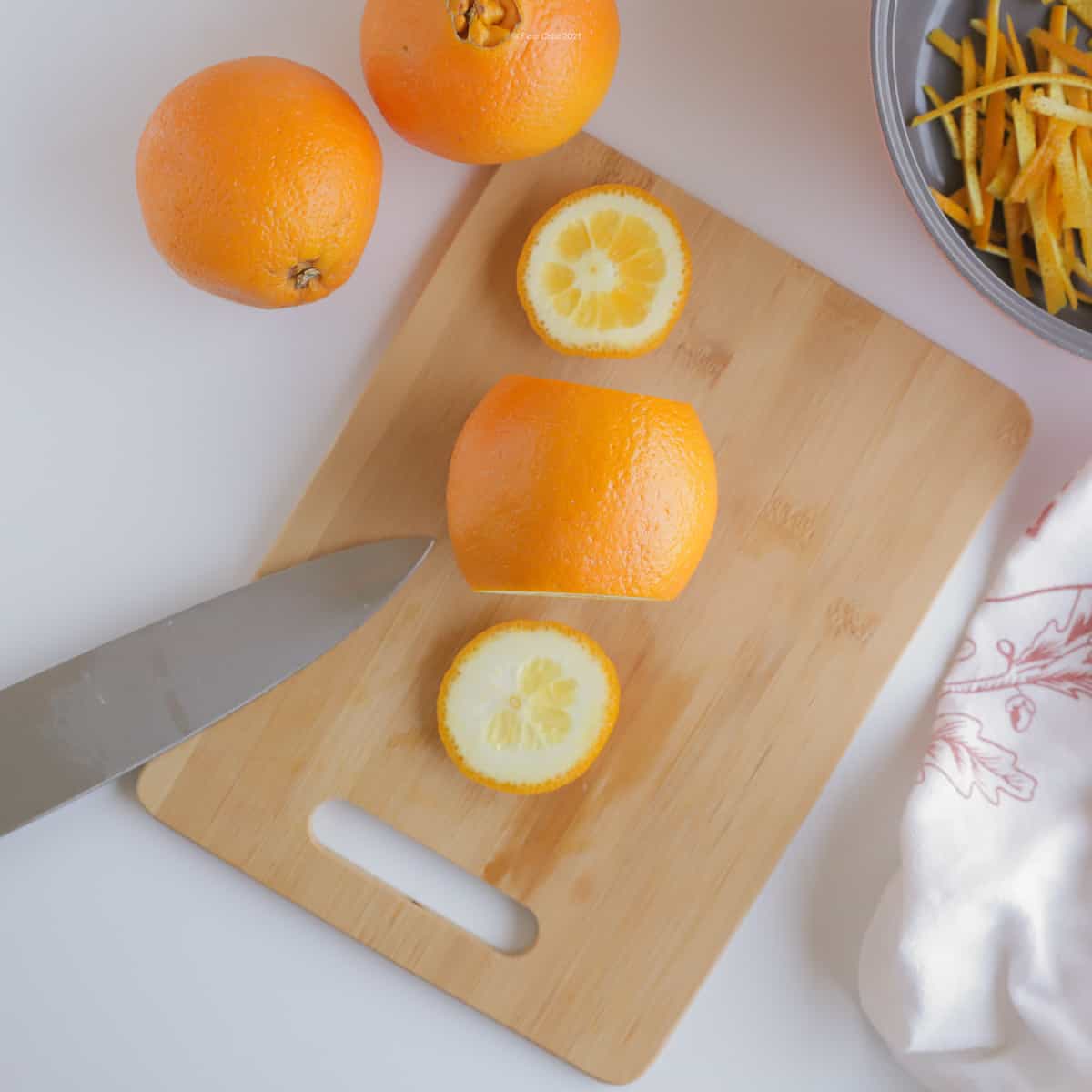 Orange on cutting board with both ends sliced off