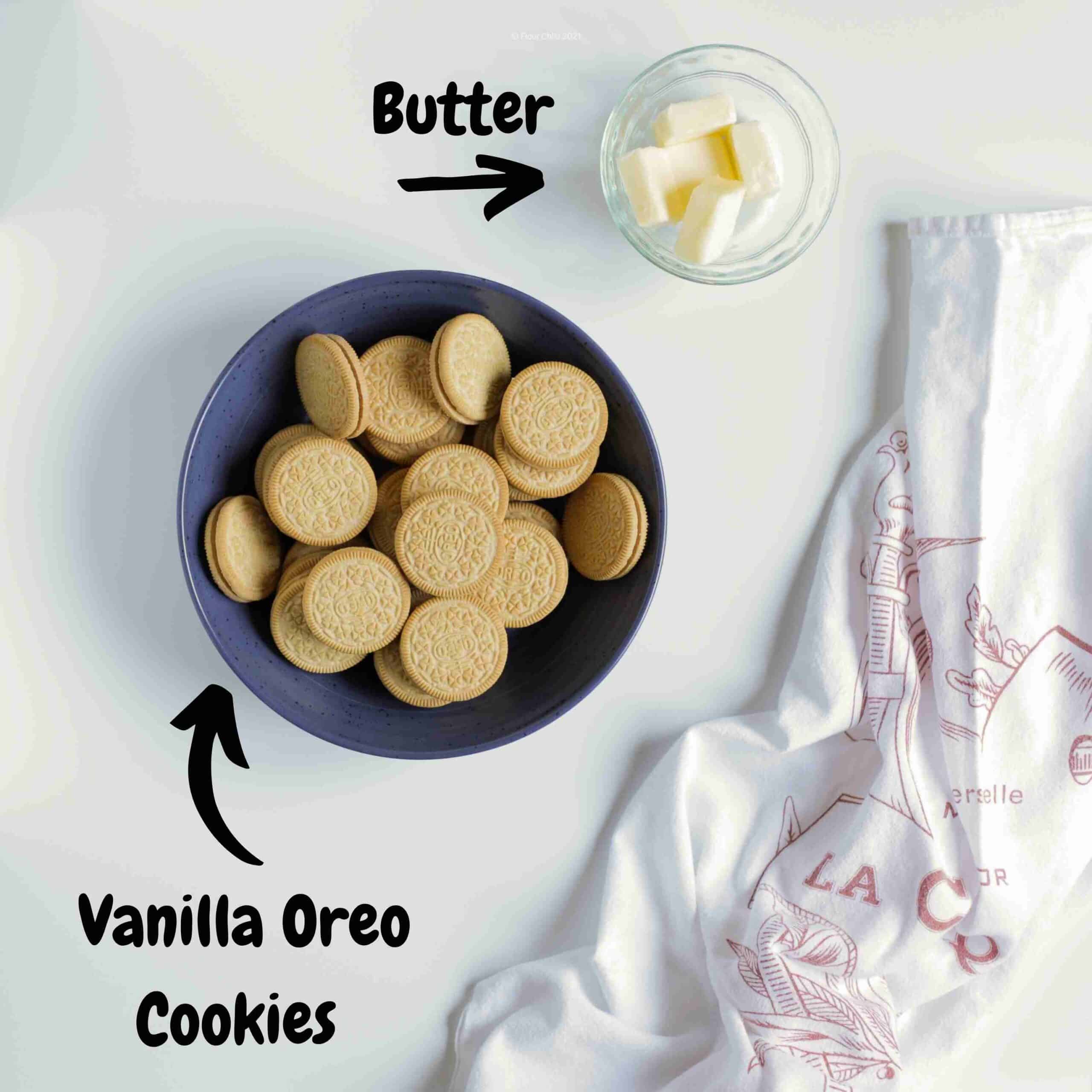 Vanilla Oreo cookies in a bowl with a small bowl of butter next to it