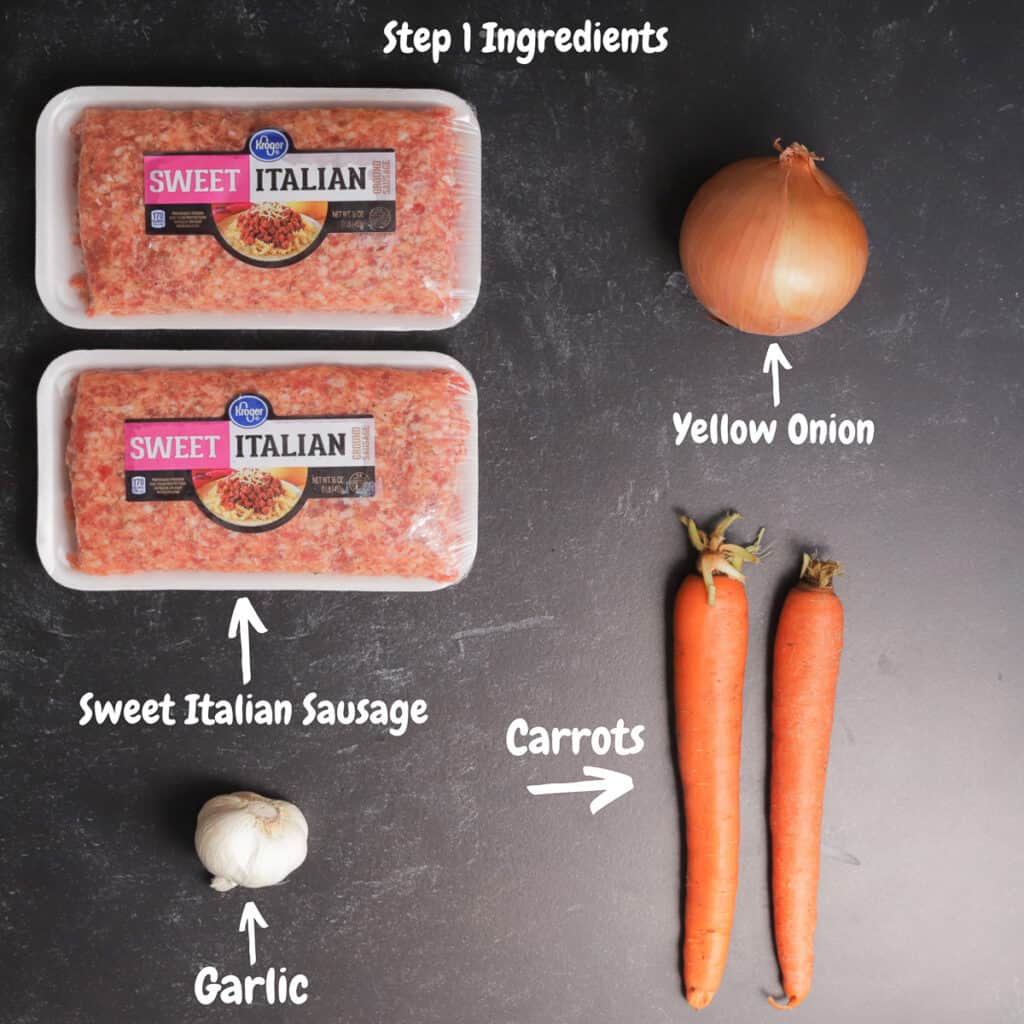 Italian sausage, onion, two carrots and a head of garlic