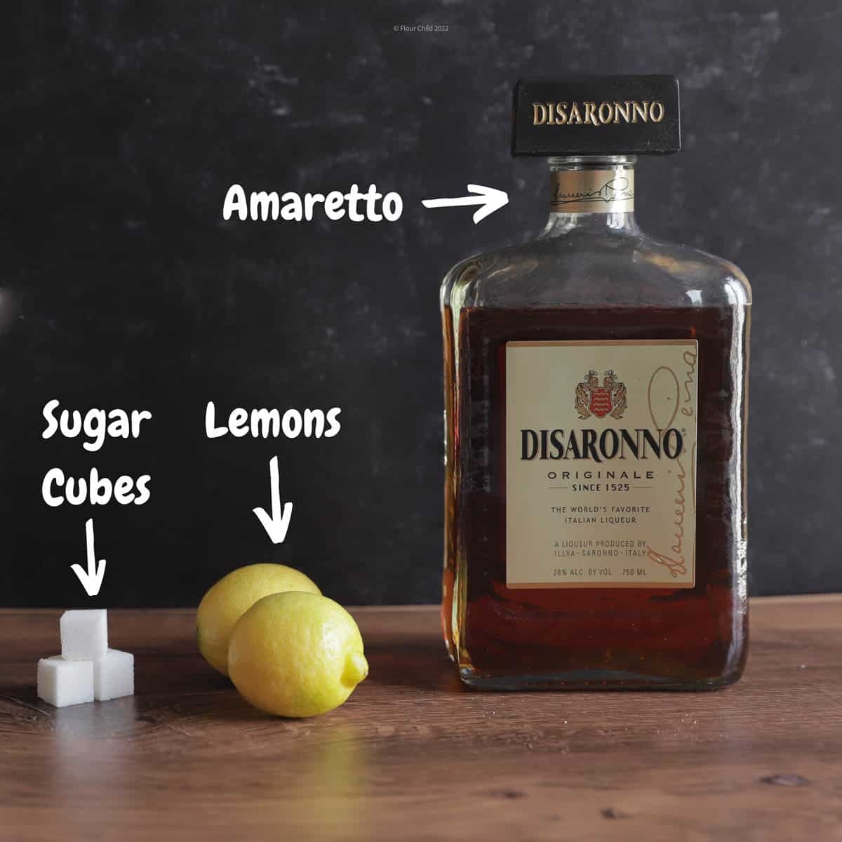 The three main ingredients used to mix a sour, liqueur lemon and sugar. Add a maraschino cherry for garnish.
