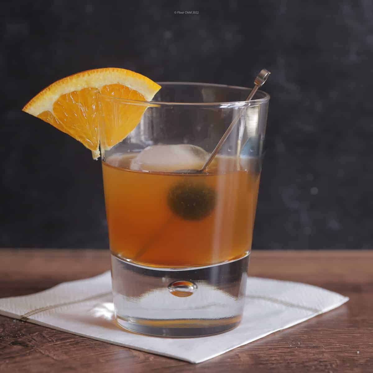 A classic amaretto sour cocktail in an old-fashioned glass with orange slice and cherry. This is the perfect amaretto sour recipe and a delicious sour drink. This is a perfect cocktail and one of the classic cocktail recipes.