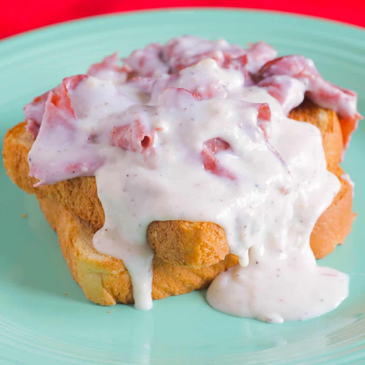 Creamed chipped beef poured over two slices of toast.