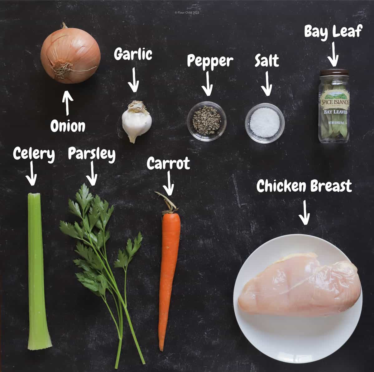 The ingredients for step 1 of cream of chicken and wild rice soup laid out on a black background.