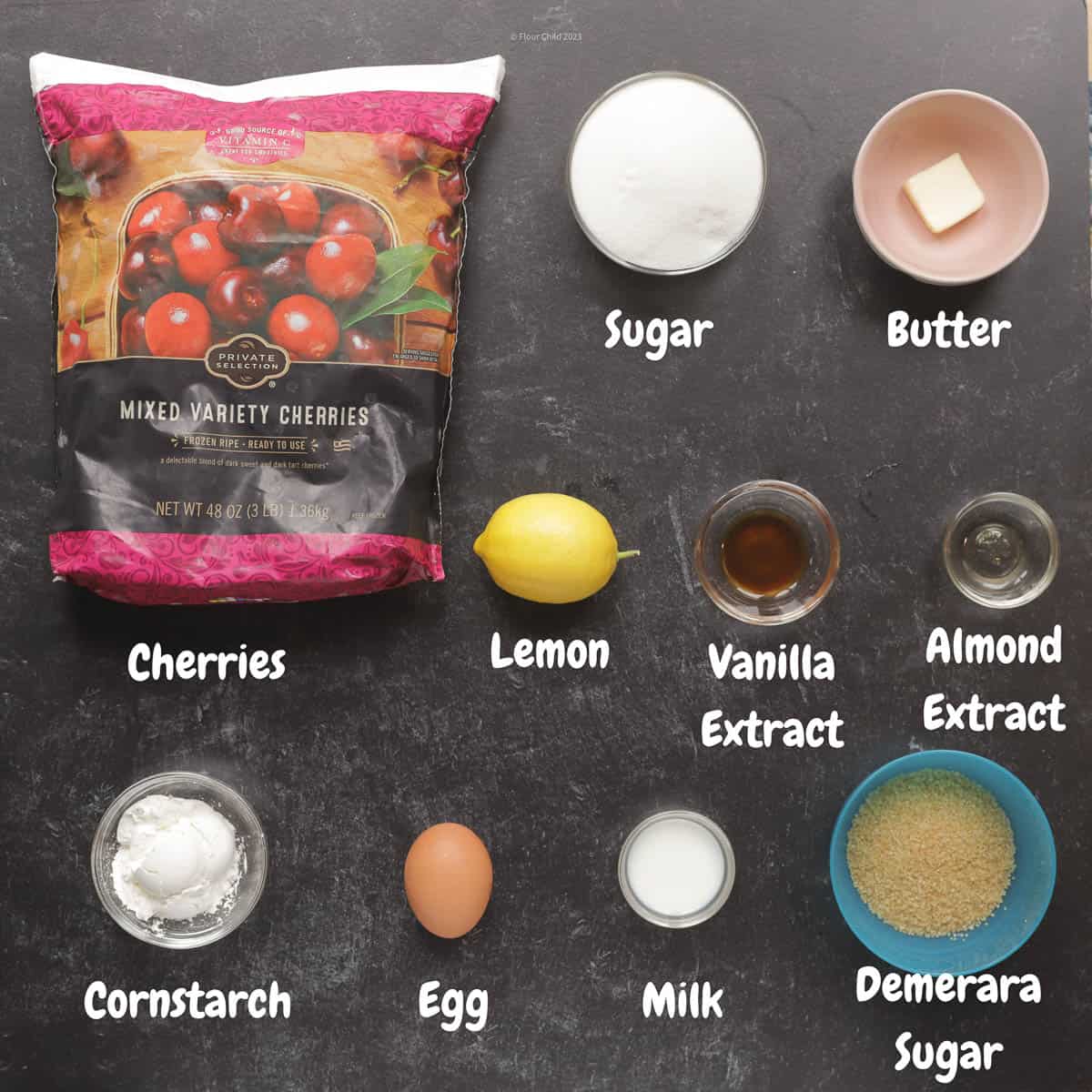 Ingredients for cherry pie filling laid out on a black background.