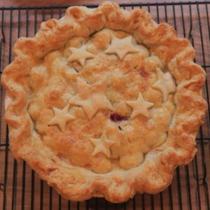 A cherry pie with a browned crust, just out of the oven.