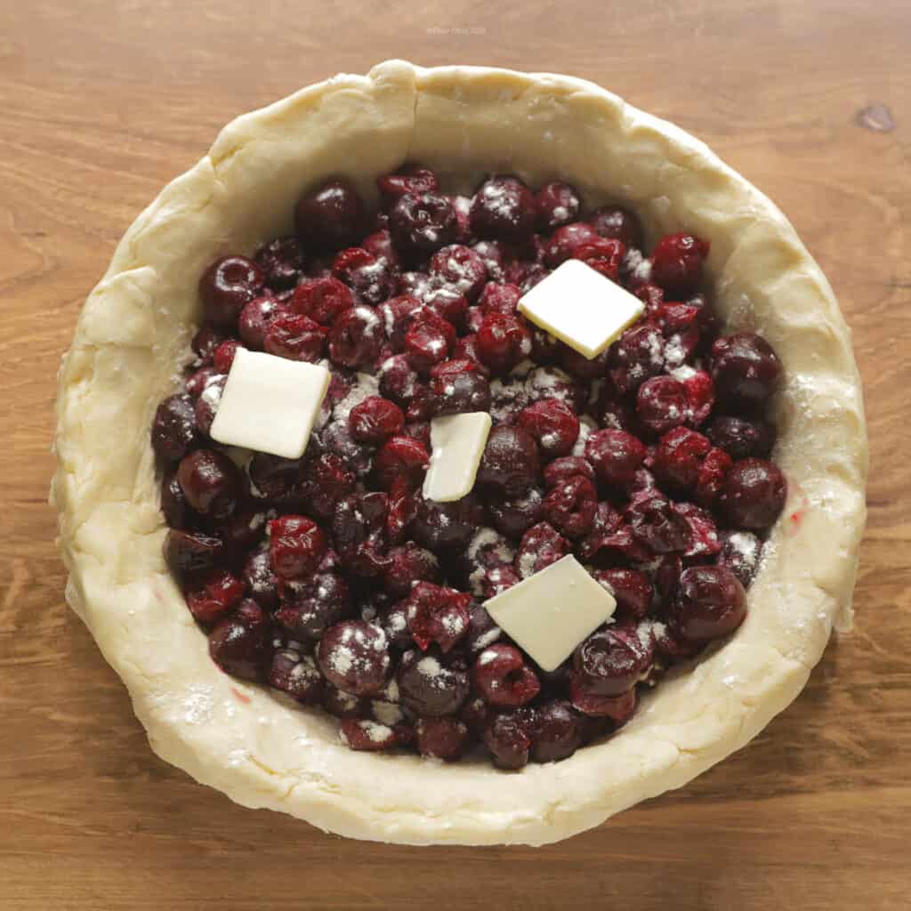 Cherries inside bottom crust with butter on top