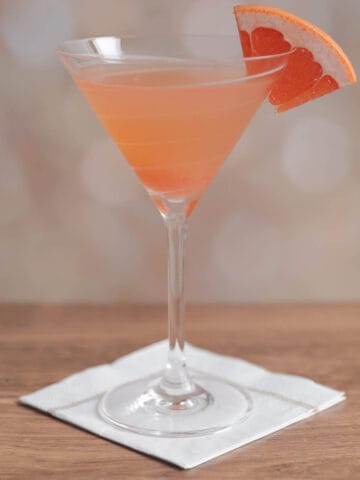 Greyhound cocktail with a grapefruit wedge in a cocktail glass