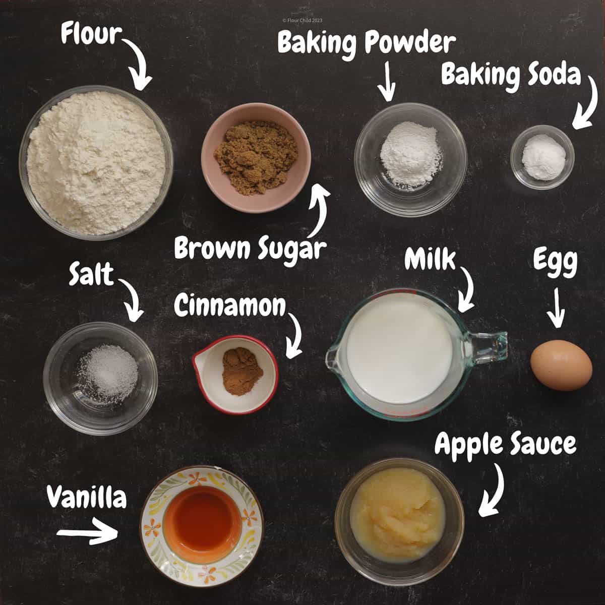 All the ingredients for cinnamon apple pancakes on a black background.