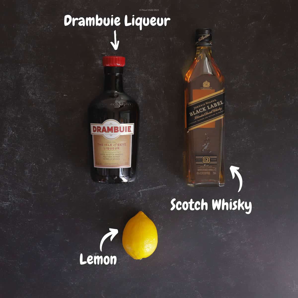 A bottle of Drambuie and a bottle of Johnnie Walker Black scotch with a lemon 