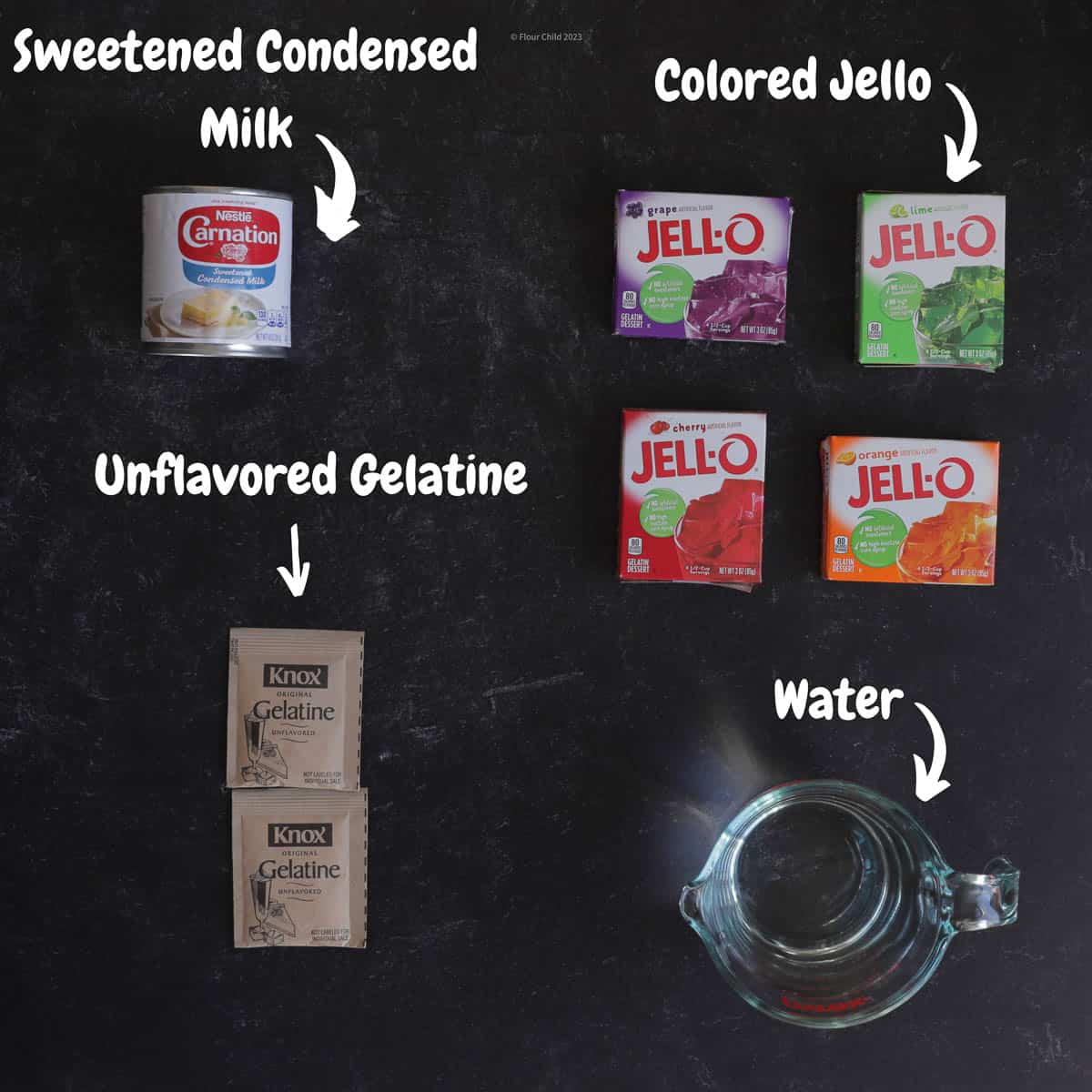 All of the ingredients needed for stained glass Jello on a black background.
