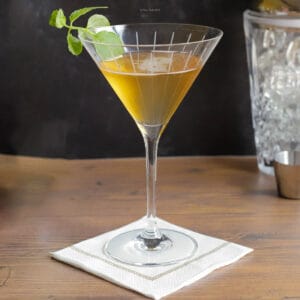 Stinger cocktail with a sprig of mint in a cocktail glass