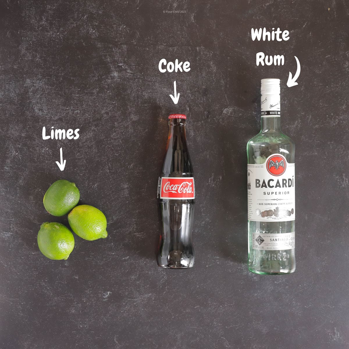 Ingredients for a Cuba Libre classic cocktail such as Coca Cola, bacardí rum and limes. The classic cuba libre cocktail recipe is super easy and can be made with simple rum (or basic rum) and a squeeze of fresh lime juice and a lime garnish make for a perfect cocktail. This coke cocktail will be be on the main menu of and is the best way to experience old Havana even from New York City. This simple drink will become your favorite drink at your local bar for good times.